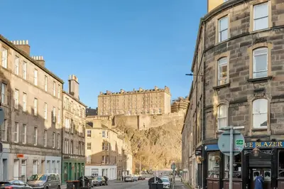 a street in an old town with buildings and a castle at Two Bedroom Apartment-Central Edinburgh-Old Town-licensed in Edinburgh