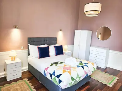a bedroom with a bed and two night stands at Spacious 2 Bedroom Apartment in the heart of New Town in Edinburgh