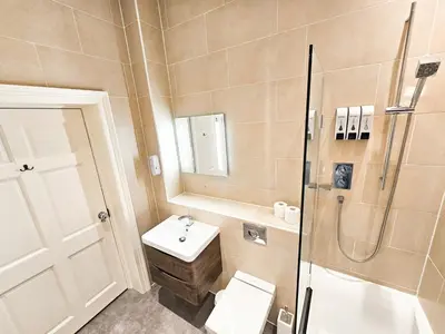 a bathroom with a toilet and a sink and a shower at Spacious 2 Bedroom Apartment in the heart of New Town in Edinburgh