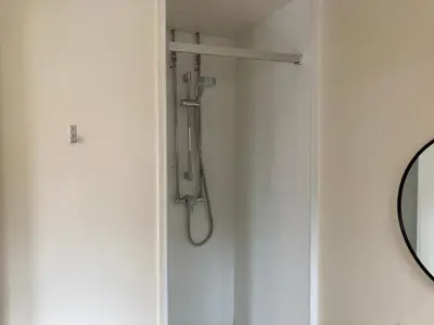a shower in the corner of a bathroom at Linlithgow Hostel in Linlithgow