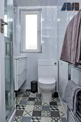 a white bathroom with a toilet and a window at Paisley Haven on Renfrew Road in Merksworth