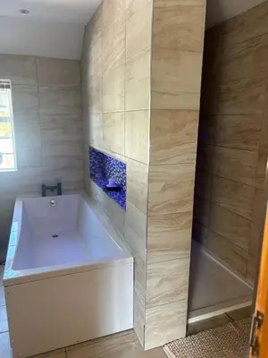 a bathroom with a white tub and a shower at Brig o Doon 2 in Ayr