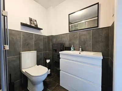 a bathroom with a toilet and a sink at Glasgow Green Modern Stay in Glasgow
