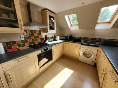 a kitchen with a sink and a washing machine at The Steadings in Kinlochleven
