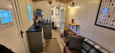 a tiny house with a kitchen and a living room at North Muasdale Farm, Ewe View in Muasdale