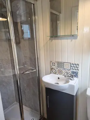 a bathroom with a sink and a shower at North Muasdale Farm, Ewe View in Muasdale