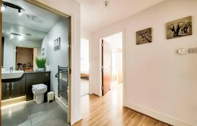 a bathroom with a toilet and a sink and a mirror at Bright & Modern Flat in Edinburgh