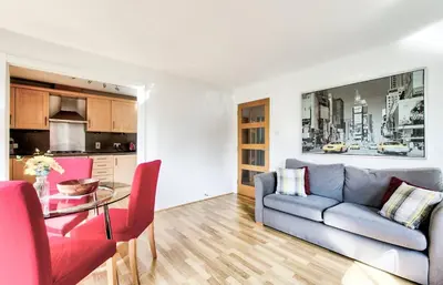 a living room with a couch and a table at Bright & Modern Flat in Edinburgh