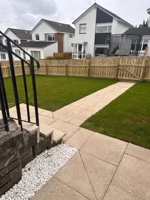 a backyard with a wooden fence and a lawn at Elite 3 bedroom family house with free parking in Newton Mearns
