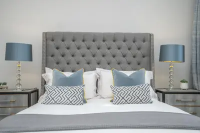 a bedroom with a large bed with pillows and two lamps at Georgian Gem in the New Town in Edinburgh