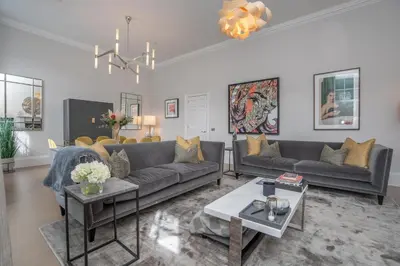 a living room with couches and a chandelier at Georgian Gem in the New Town in Edinburgh
