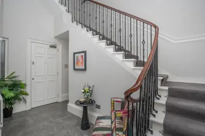 a staircase in a home with white walls at Georgian Gem in the New Town in Edinburgh