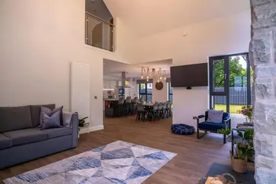 a living room with a couch and a table at Lowwood Lodges in Houston