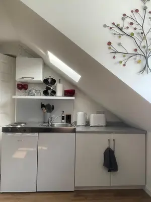 a kitchen with white cabinets and a sink at Foundry Street Apartment 2 - Dunfermline city centre in Dunfermline