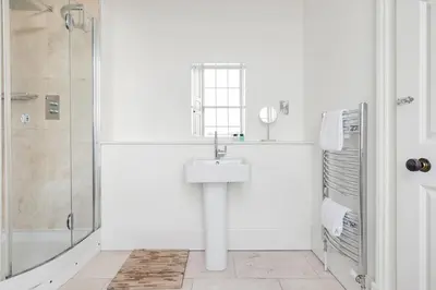 a bathroom with a sink and a shower at Super Central - Georgian Double Upper Flat with Castle Views in New Town in Edinburgh
