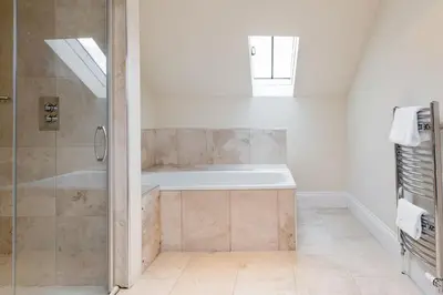 a bathroom with a shower and a bath tub at Super Central - Georgian Double Upper Flat with Castle Views in New Town in Edinburgh