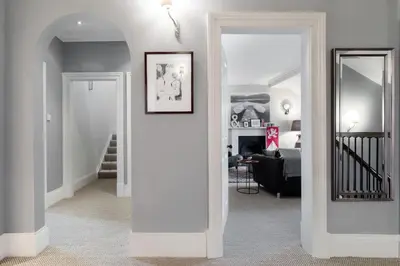 a living room with a hallway with a mirror at Super Central - Georgian Double Upper Flat with Castle Views in New Town in Edinburgh