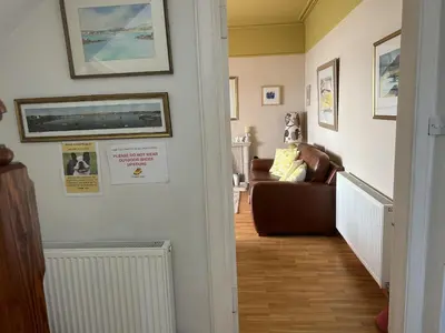 a hallway with a living room with a couch at Unique house in an idyllic situation on a beach in Port Ellen