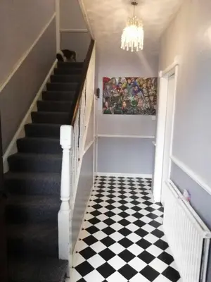 a hallway with a black and white checkered floor at Silverknowes Silver room sleeps 4 with private shower in Edinburgh