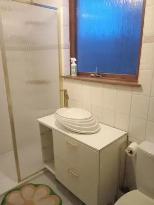 a bathroom with a toilet and a sink and a mirror at Silverknowes Silver room sleeps 4 with private shower in Edinburgh