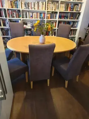 a table in a library with chairs and a vase on it at Silverknowes Silver room sleeps 4 with private shower in Edinburgh