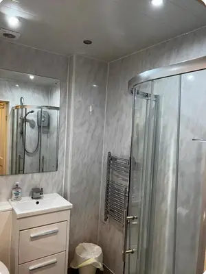 a bathroom with a shower and a sink at Homely in Hampden in Glasgow