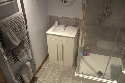 a bathroom with a sink and a shower at The Old Mill Bed & Breakfast in Biggar