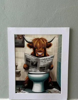 a picture of a cow sitting on a toilet with a newspaper at West Dunbartonshire Flat, near Loch Lomond in Dumbarton