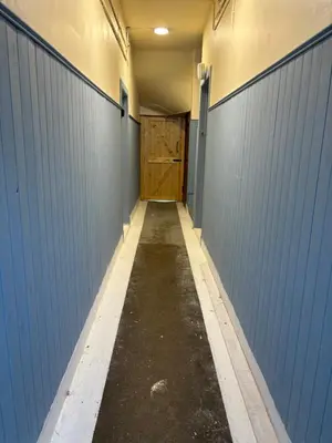 a hallway of a barn with a wooden door at Largs Seaside Loft 2 R in Largs