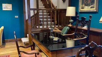 a room with a staircase and a glass table at Beautiful House With Gardens Close To River Tay in Remony