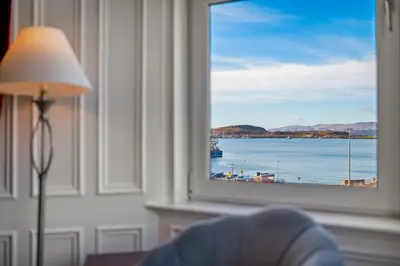 a window with a view of a body of water at Oban Bay Views - Fireplace, Games & Books in Oban
