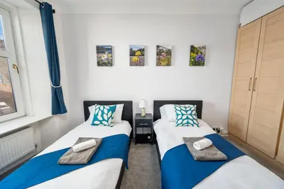 two beds sitting next to each other in a room at Oban Bay Views - Fireplace, Games & Books in Oban