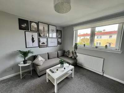 a living room with a couch and a table at ClydeBank Brand new 3BDR Home, Glasgow in Clydebank