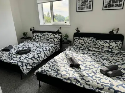 two beds sitting next to each other in a bedroom at ClydeBank Brand new 3BDR Home, Glasgow in Clydebank