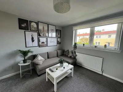 a living room with a couch and a table at ClydeBank Brand new 3BDR Home, Glasgow in Clydebank