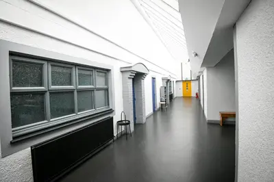 an empty hallway of a building with windows and a hallway sidx sidx at Cunninghame 4 in Beith