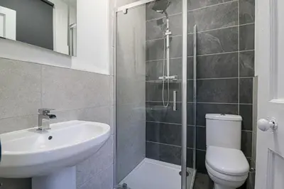 a bathroom with a sink and a toilet and a shower at Marchfield Promenade View in Prestwick