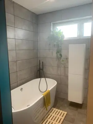 a white bath tub in a bathroom with a window at House Aurora in Edinburgh