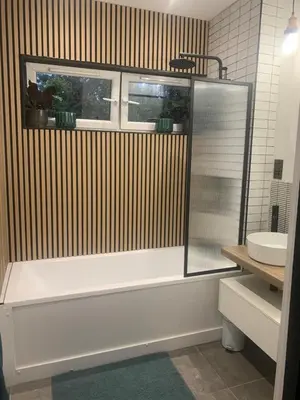 a bathroom with a white tub and a sink at House Aurora in Edinburgh