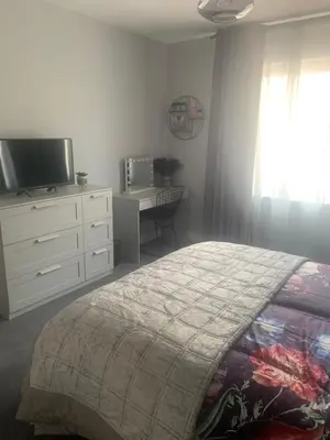 a bedroom with a bed and a tv and a dresser at House Aurora in Edinburgh