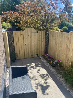 a bench sitting in front of a fence at Glasgow Apartment close to the airport in Renfrew