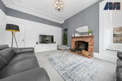 a living room with a couch and a fireplace at Albert Road in Gourock