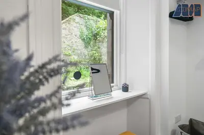 a window with a mirror on a shelf at Albert Road in Gourock