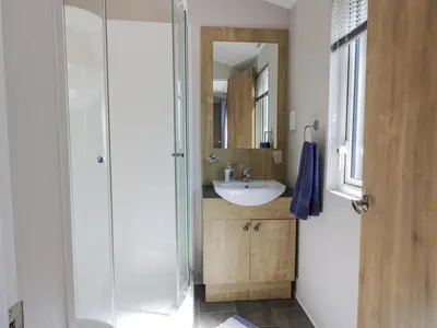 a bathroom with a sink and a glass shower at Bethany's Retreat in Wemyss Bay