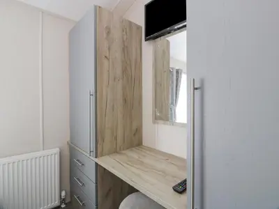 a small room with a desk and a refrigerator at Olivia's Haven in Wemyss Bay