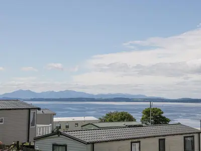 a view of a large body of water with buildings at Olivia's Haven in Wemyss Bay