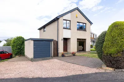 a house with a garage in front of it at 20 mins to Edinburgh 3 bedroom detached family house Wi-Fi Parking in Fife