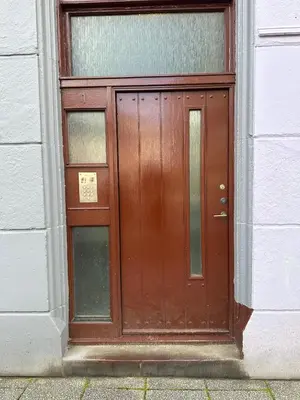 a brown door on a building with a window at Heart of Oban in Oban