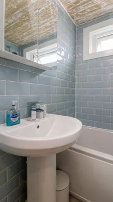 a bathroom with a sink and a bath tub at Modern And Cozy Apex Apartment in Helensburgh