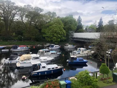 a group of boats are docked in a marina at Loch Lomond Riverside Apartments A in Balloch